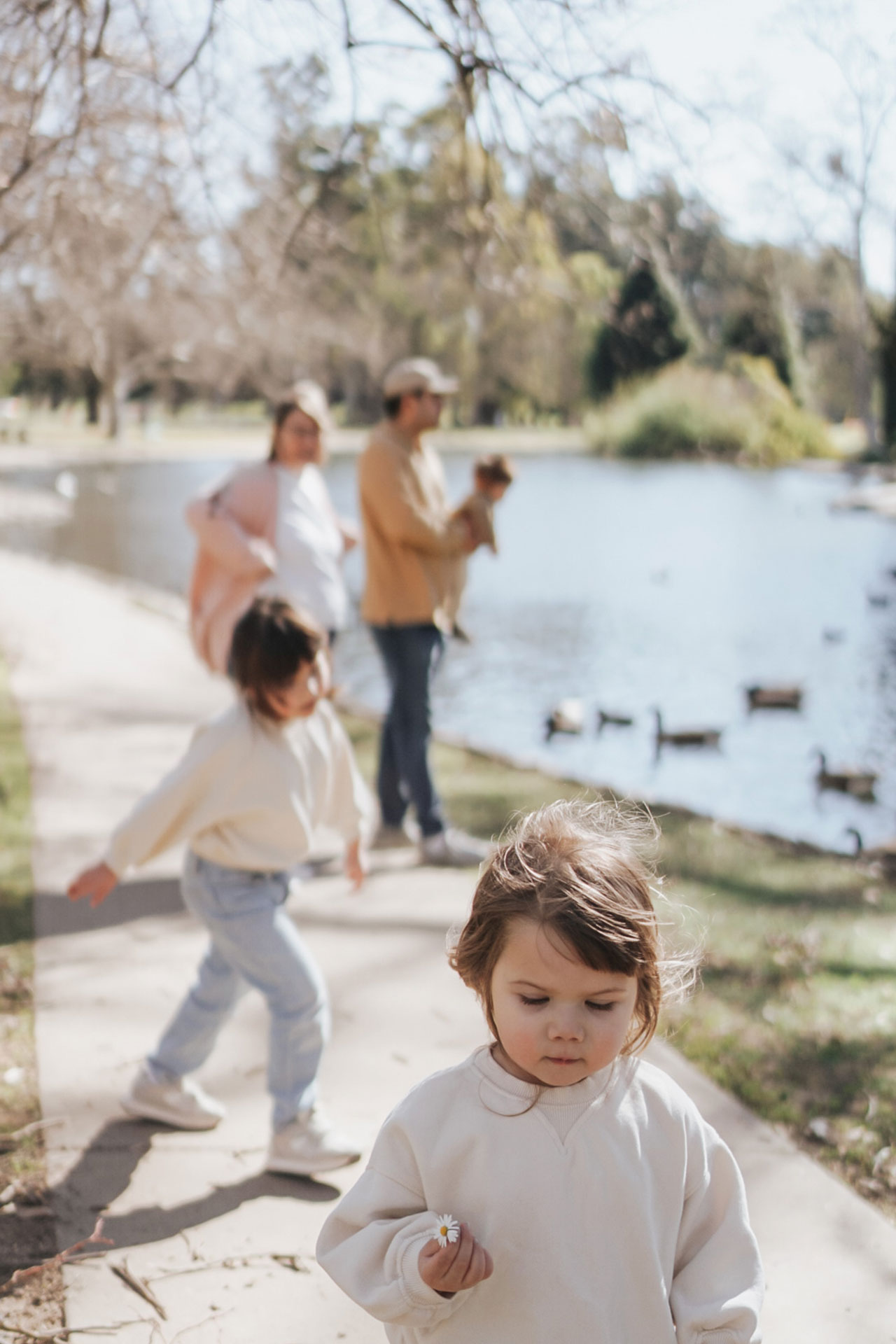 Photograph of Family at the Park Feeding Ducks at a Pond After Preset Application
